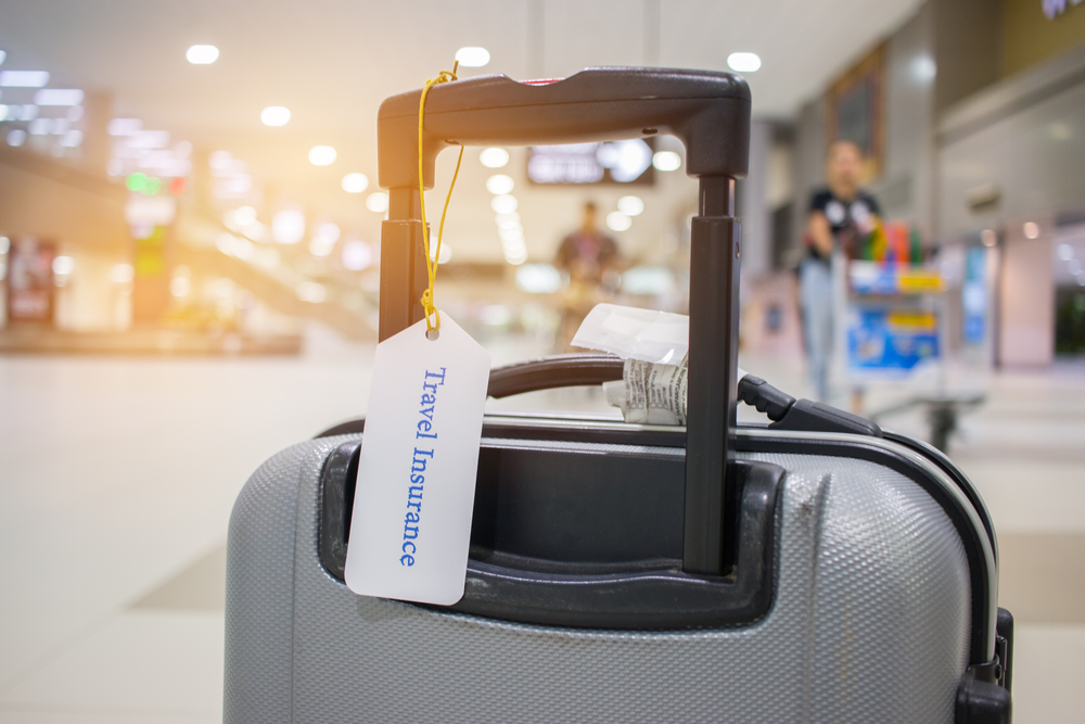 Travel,Insurance,Tag,On,Suitcase,Holder,With,Tag,Tied,Letters Travel,Insurance,Tag,On,Suitcase,Holder,With,Tag,Tied,Letters